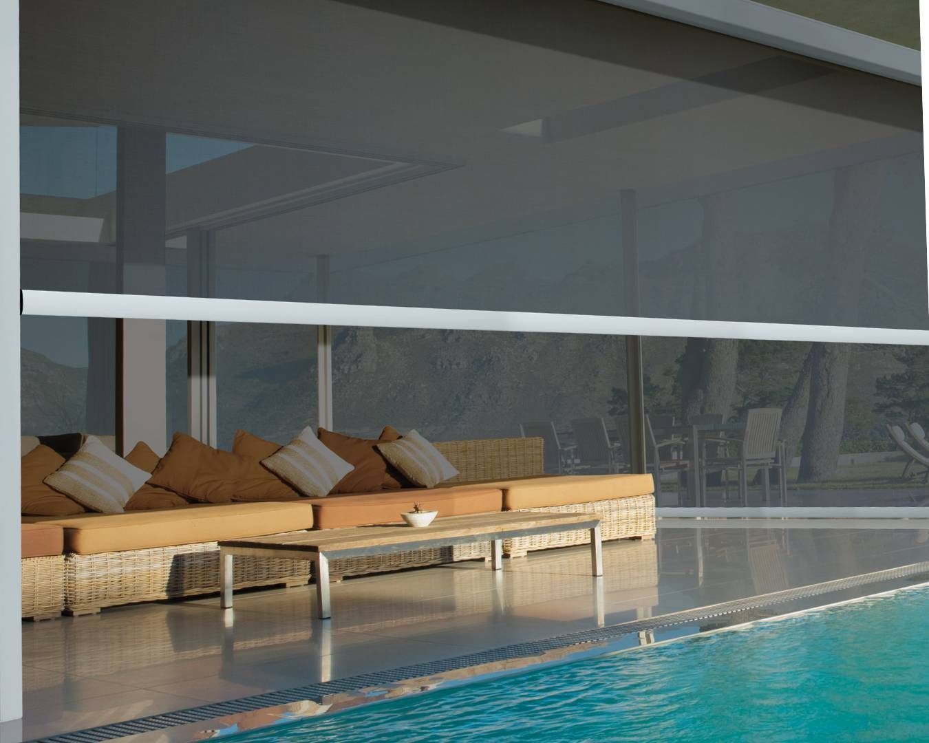 A swimming pool with a couch and table in front of it