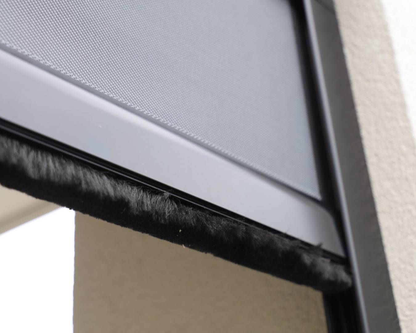 A close up of a screen door on a building