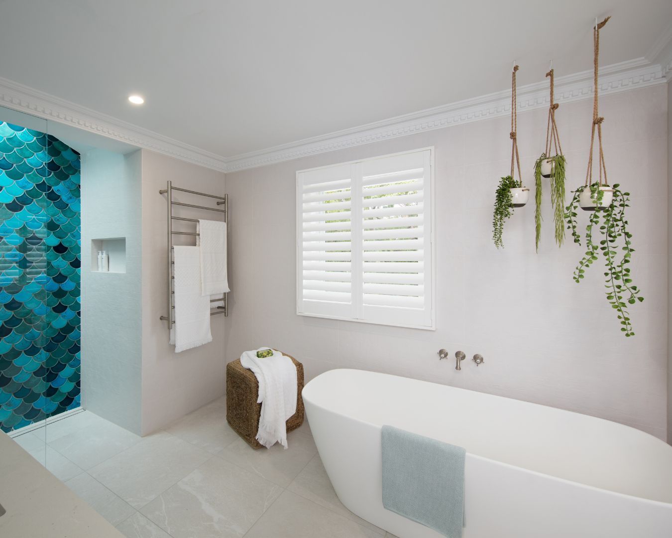 A bathroom with a tub , shower and window.