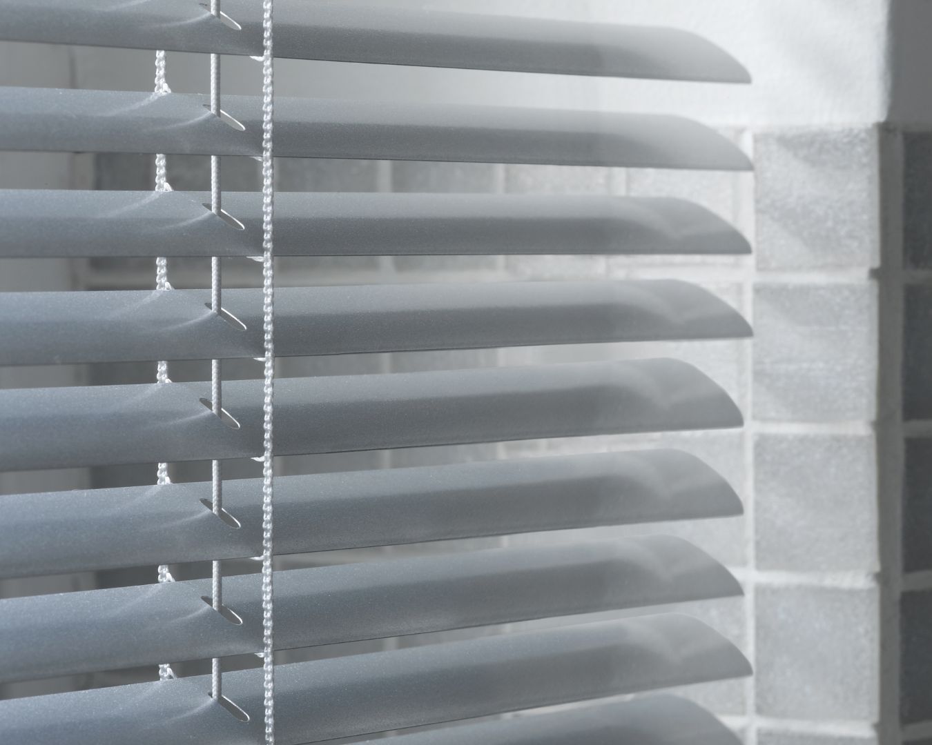 A close up of a window with blinds on it