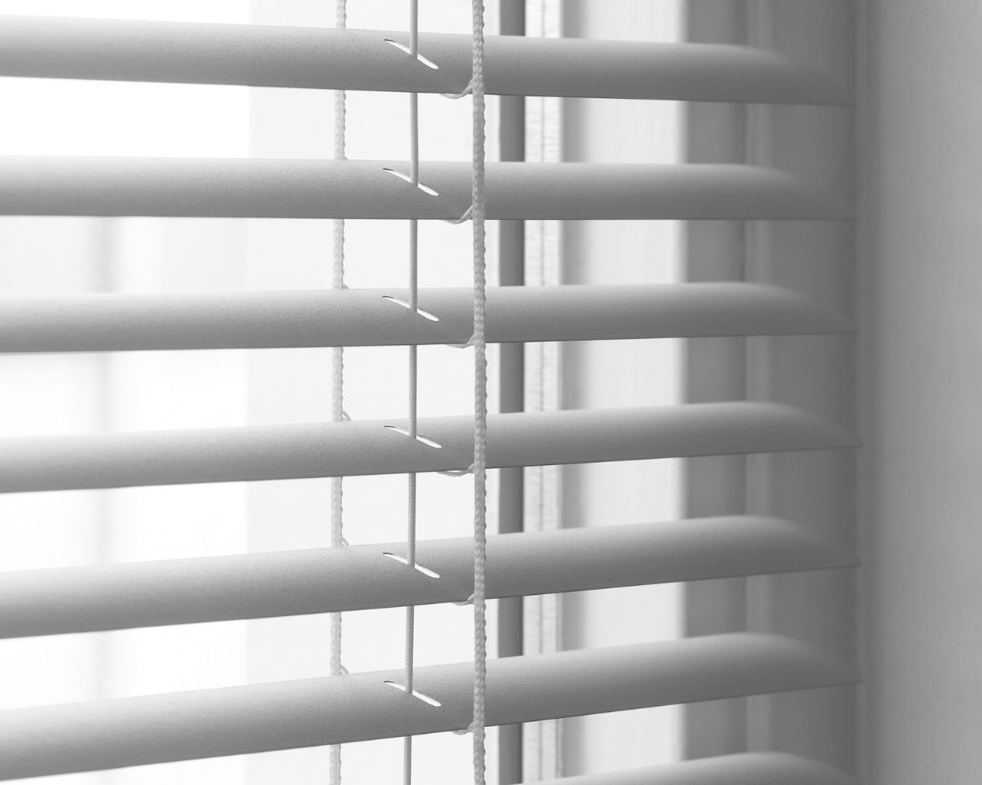 A close up of a window with blinds on it