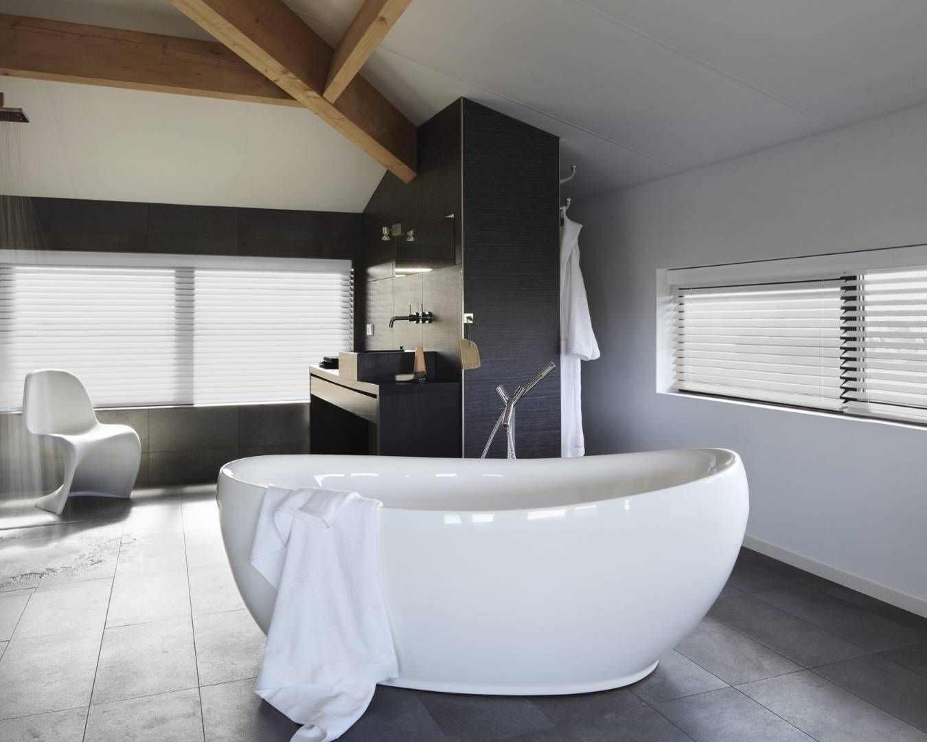 A bathroom with a bathtub and a chair