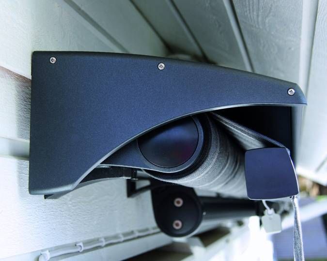 A black awning is attached to the side of a building