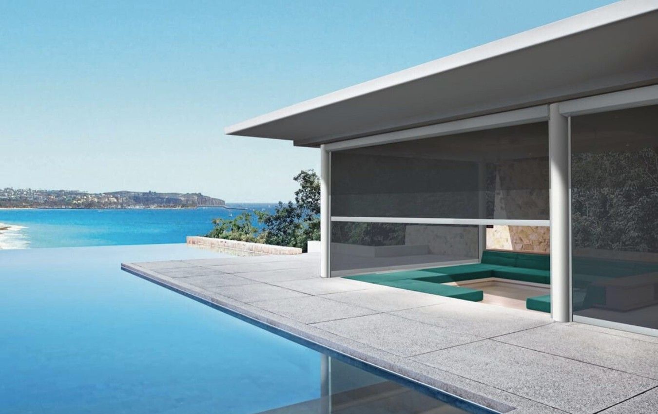 A house with a swimming pool and a view of the ocean