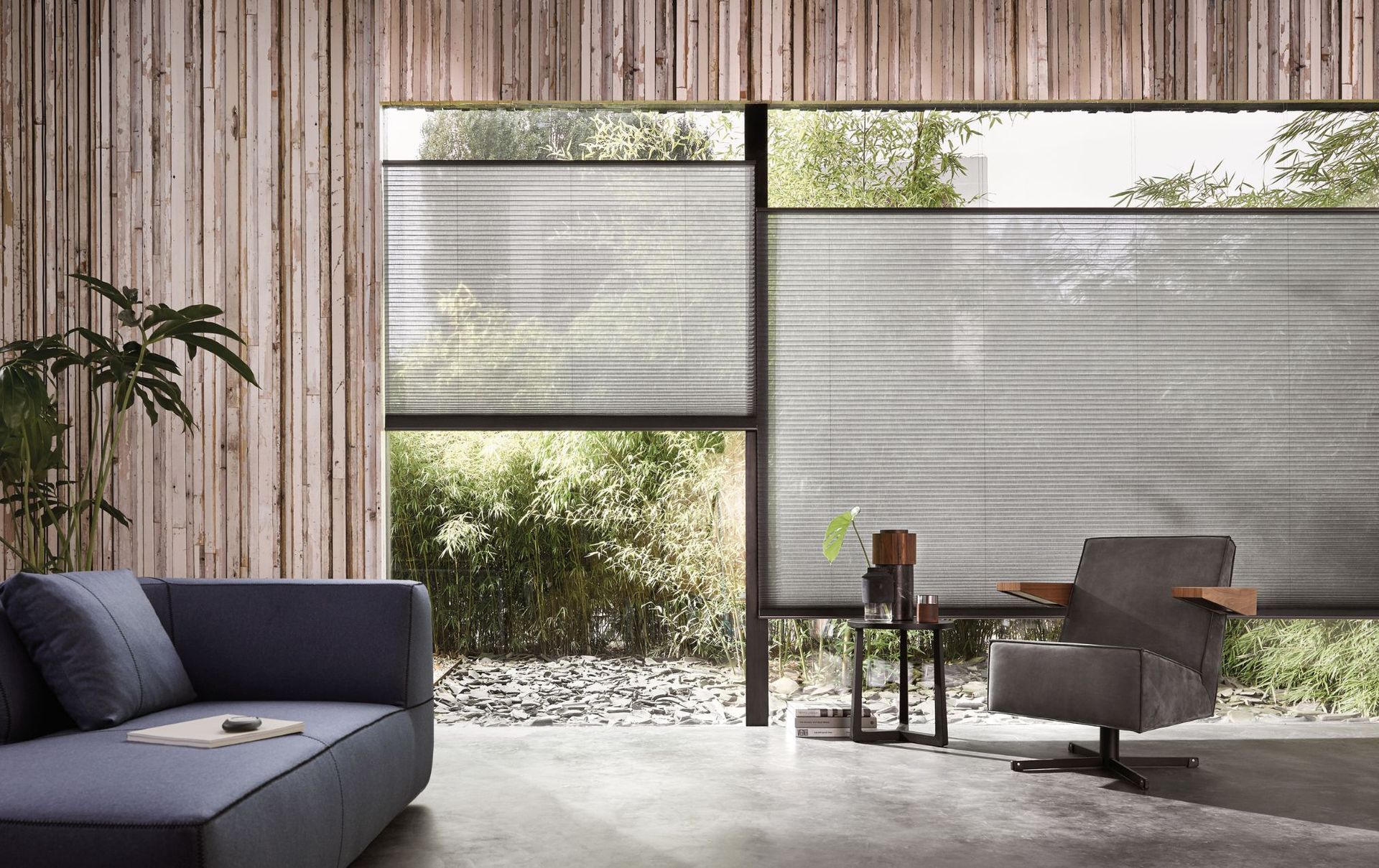 A modern living room and a window with honeycomb blinds.