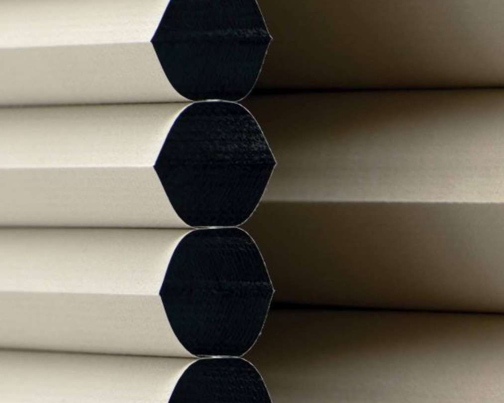 A close up of a stack of honeycomb blinds