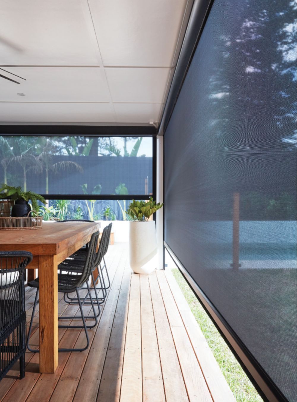 A dining room with a table and chairs and a large window