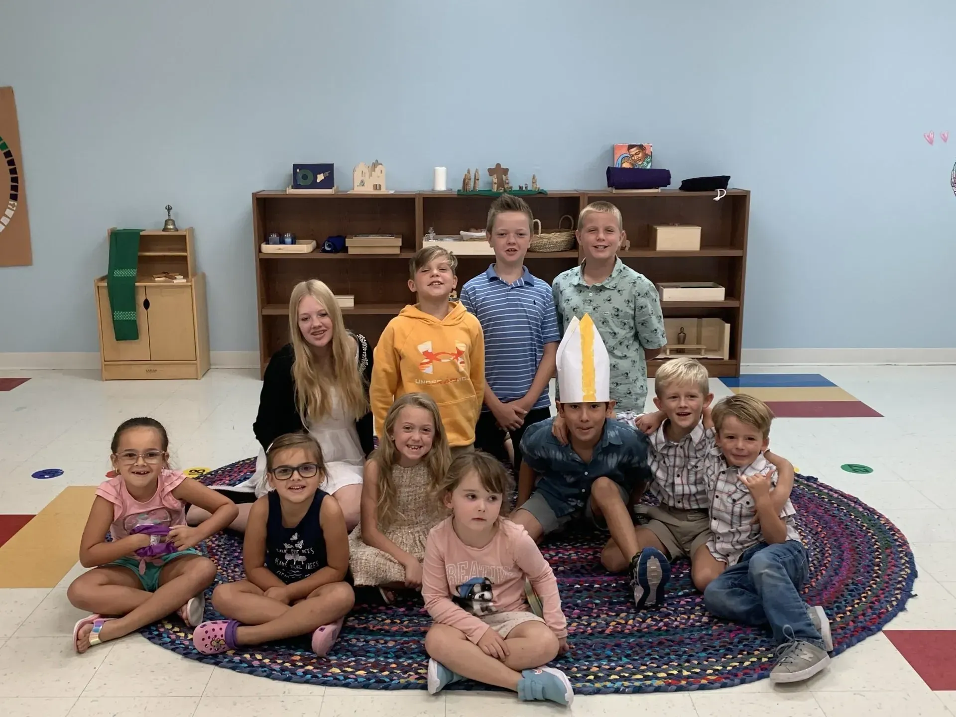 A group of children are posing for a picture in a room.