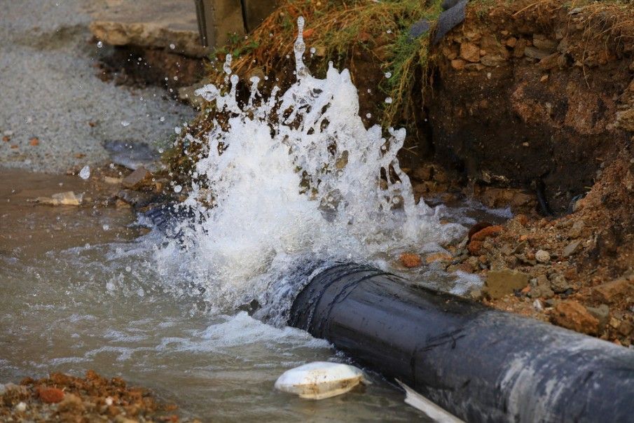 Water is Coming Out of a Pipe and Splashing on the Ground — Wade N Water In Moree, NSW
