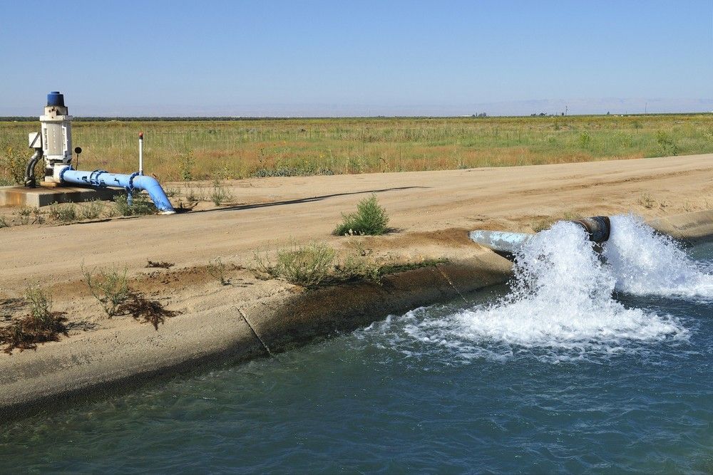 A Pump is Pumping Water Into a Body of Water — Wade N Water In Quirindi, NSW