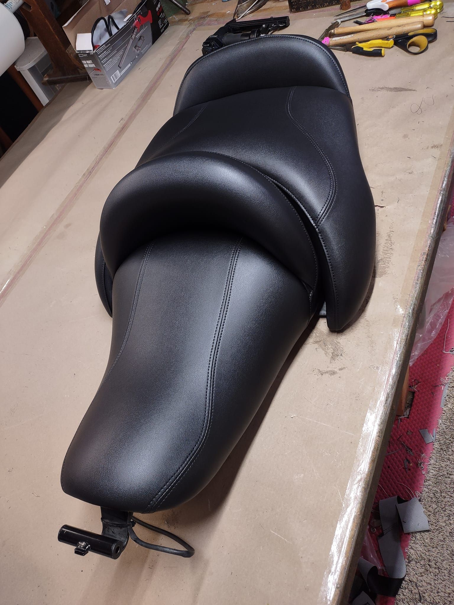 A motorcycle seat is sitting on top of a table.