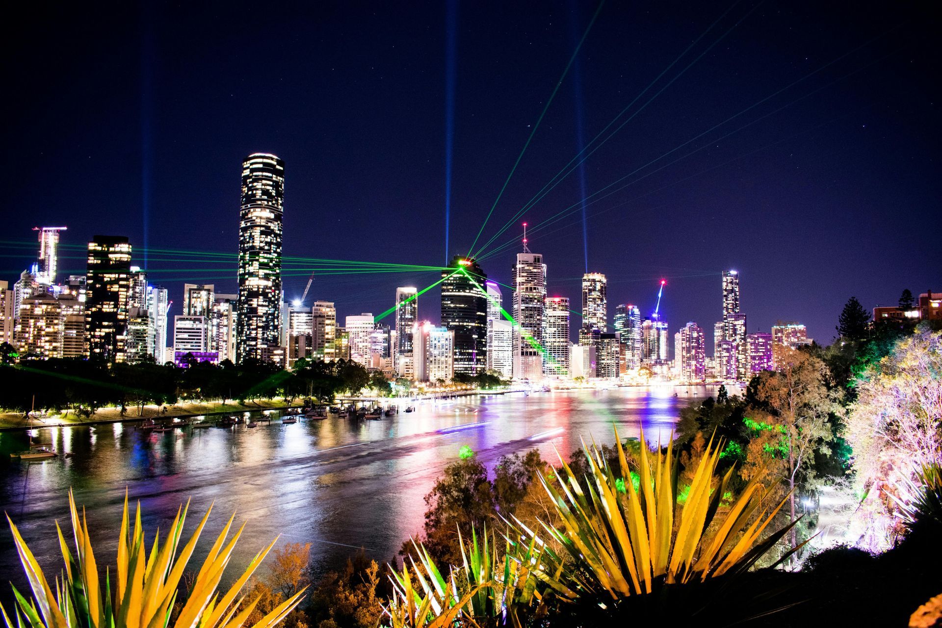 Brisbane skyline at sunset, with tall buildings along the river.