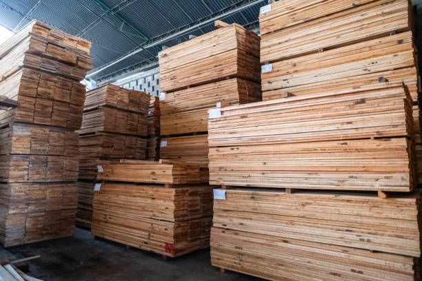 Planks of timber organized in a woodshop or lumberyard warehouse for efficient lumber supply.