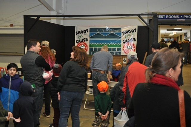 People gathered at a booth with banners that say 