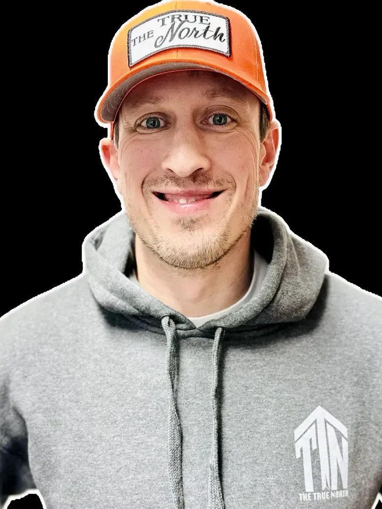 Man in orange hat and gray hoodie smiling, with logo 