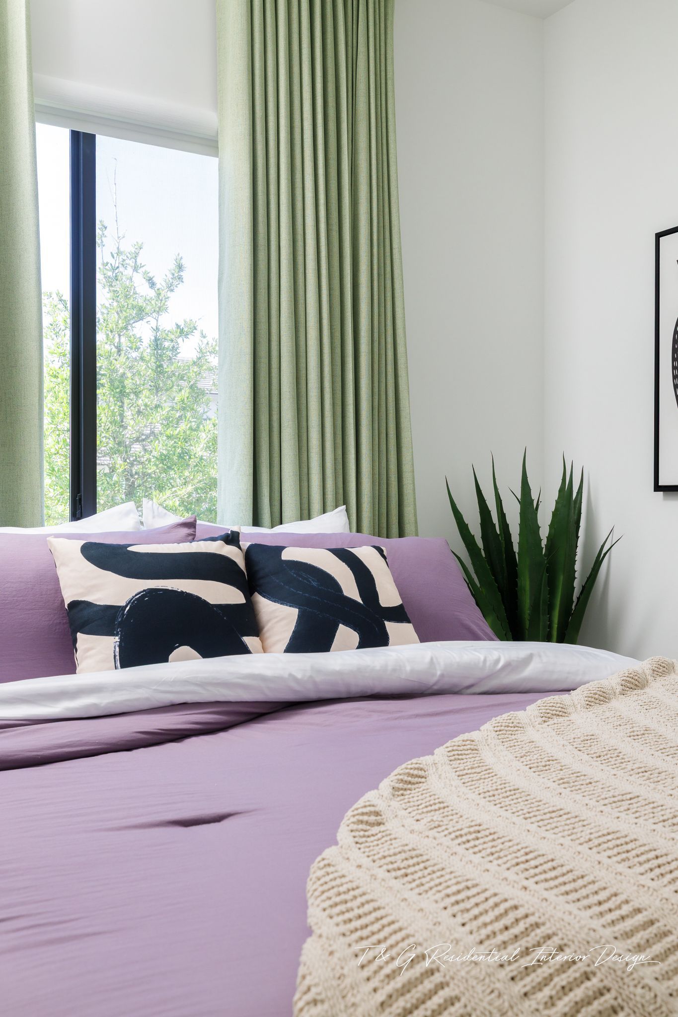 A bedroom with a bed, chair, and rug.