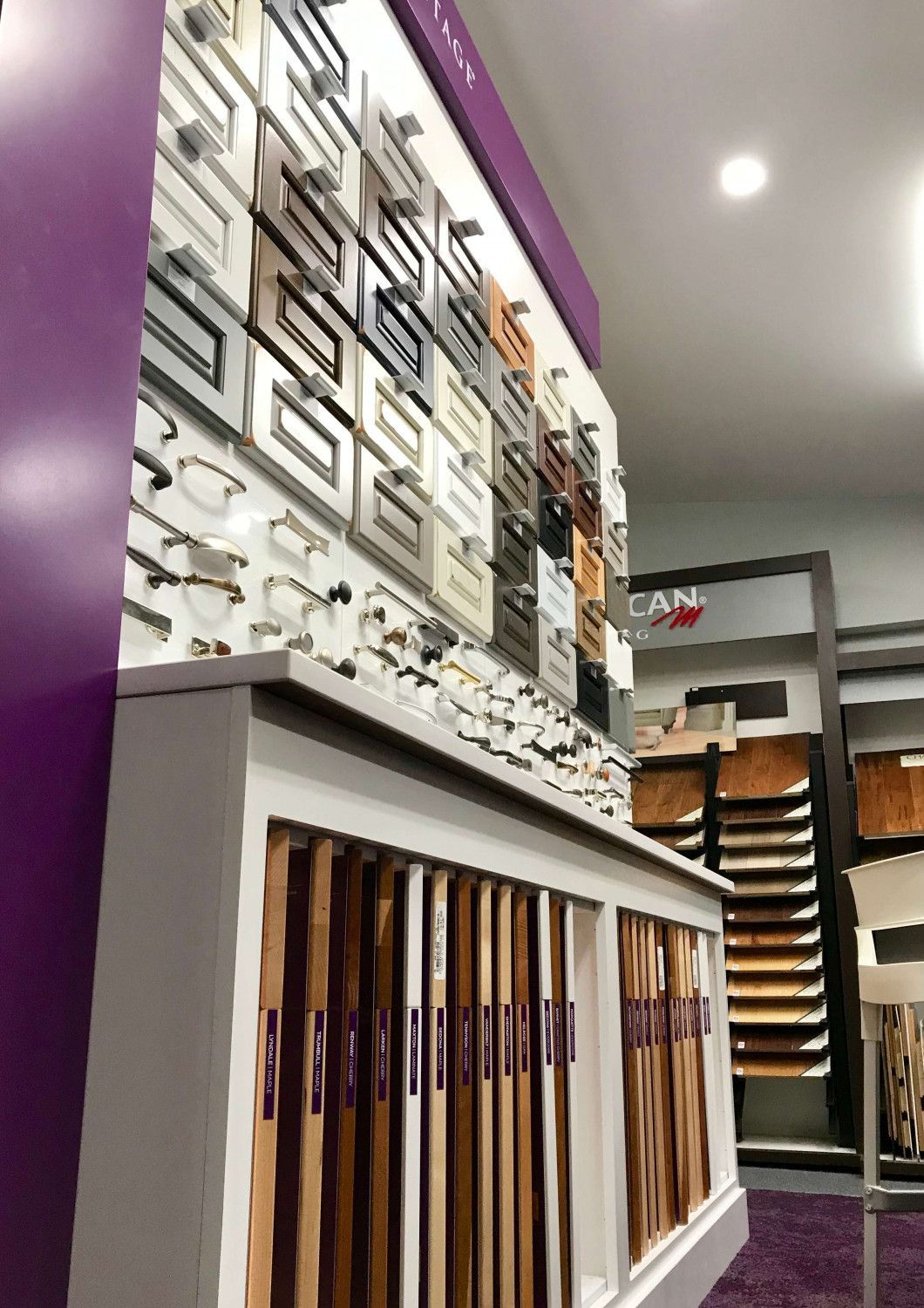 Wall display of framed samples and wood moldings in a home decor showroom