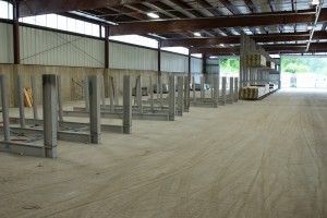 Empty industrial warehouse with metal framing and a concrete floor