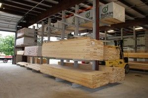 Large bundles of lumber stacked in a covered lumberyard