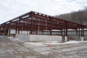 Steel-frame building under construction on a snowy site