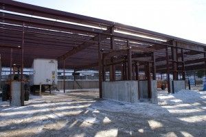 Partially built steel warehouse frame on a snowy construction site