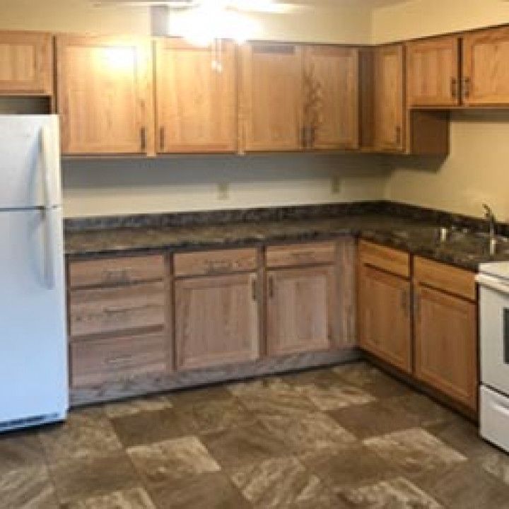 Kitchen With Wooden Cabinets and Granite Counter Tops