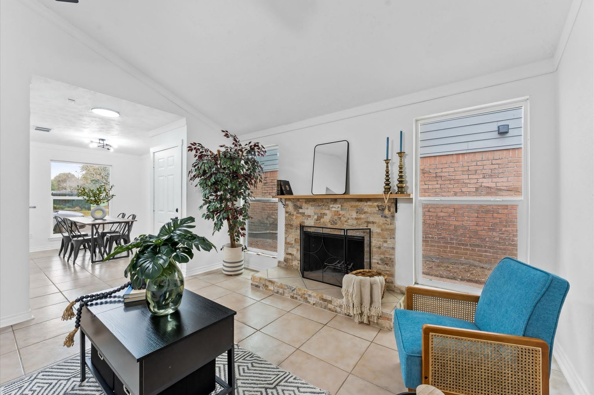A living room with a fireplace and a blue chair.