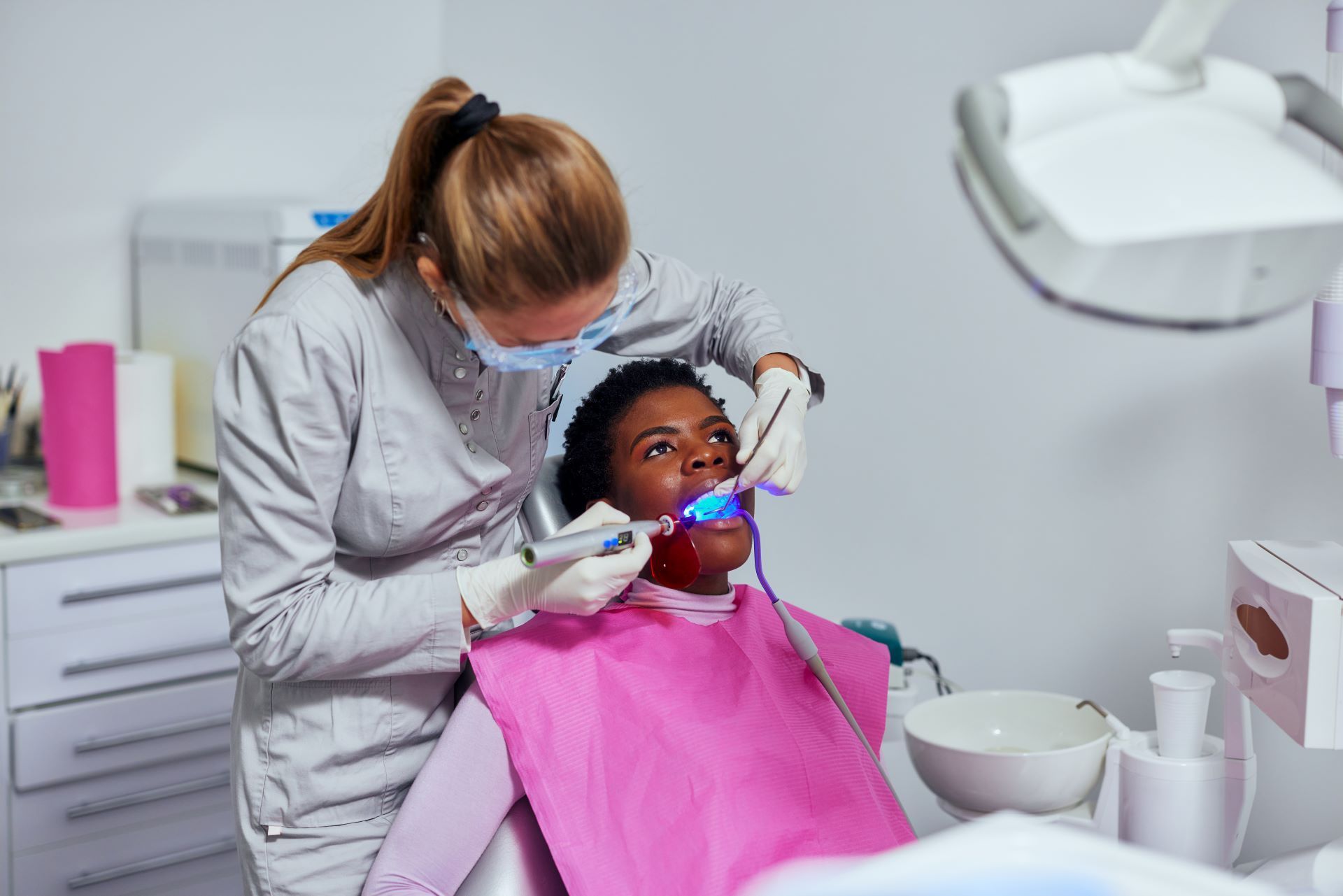 Dentist examining a patient in a dental chair during treatment