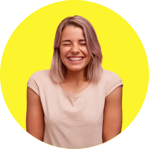 A person with light-colored hair and braces smiling widely with eyes closed against a bright yellow circular background.