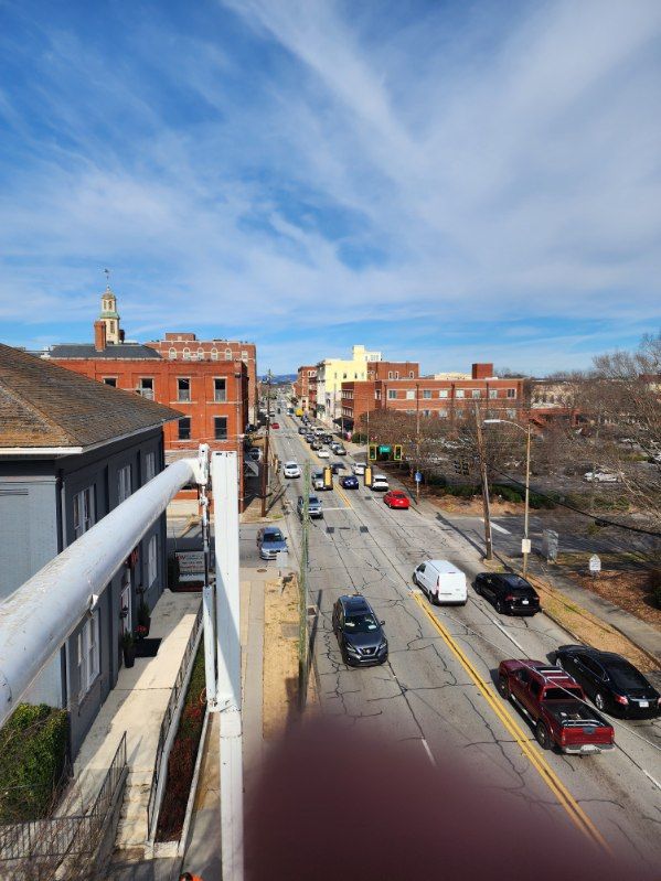 An aerial view of a city street with cars driving down it