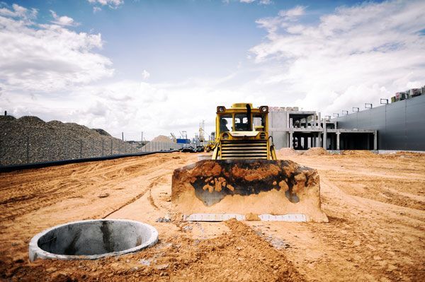 A bulldozer is moving dirt on a construction site.