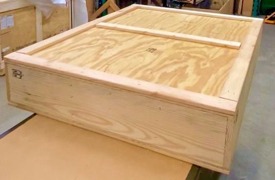 A plywood crate, with the item being wrapped contained inside (not visible in the image as the crate was finished and closed)