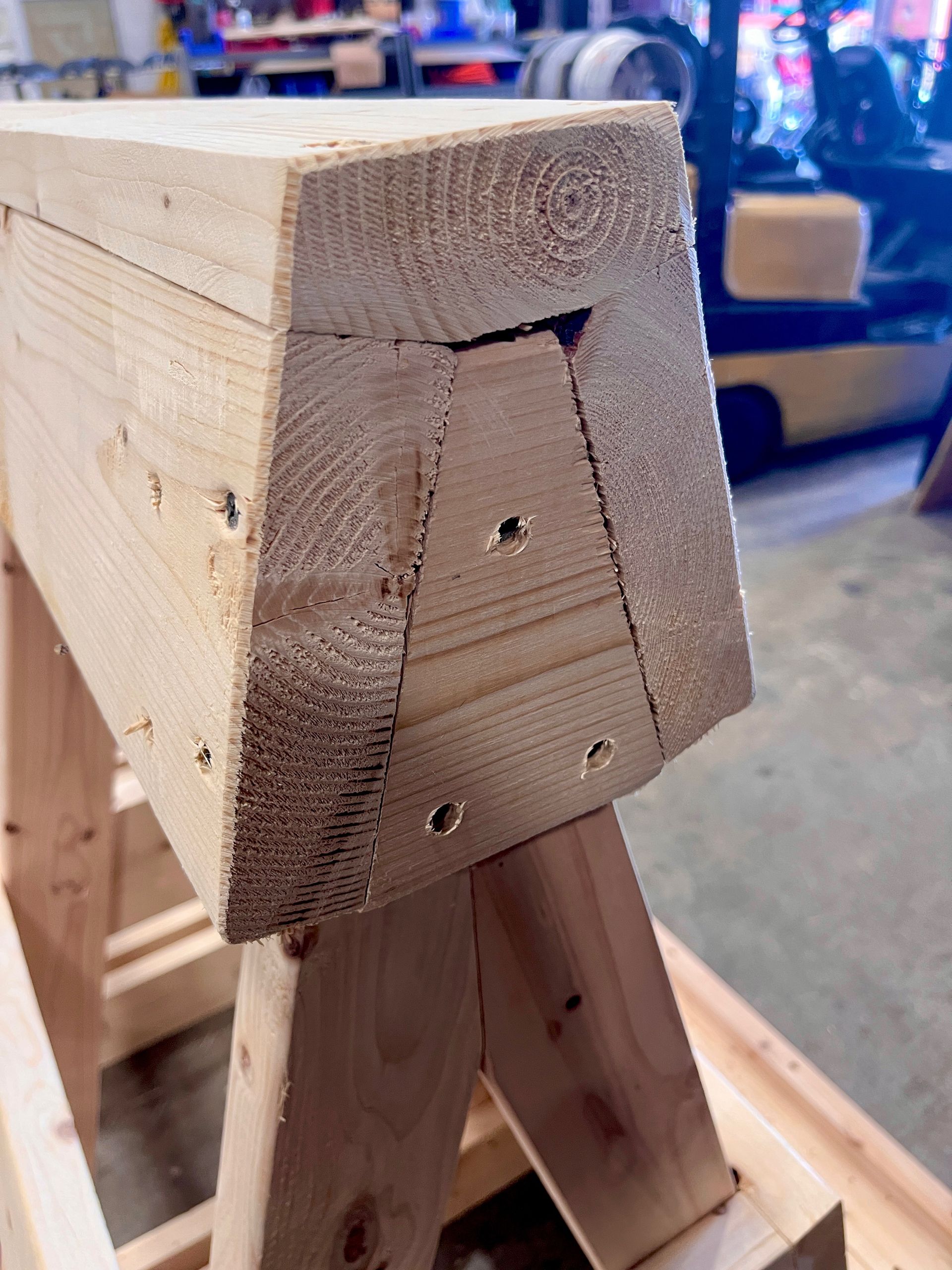 The top of A-frame glass storage rack, prior to addition of felt. Several wooden planks have been modified from their original rectangular prism shape; they have been angled so they can sit flush with each other.