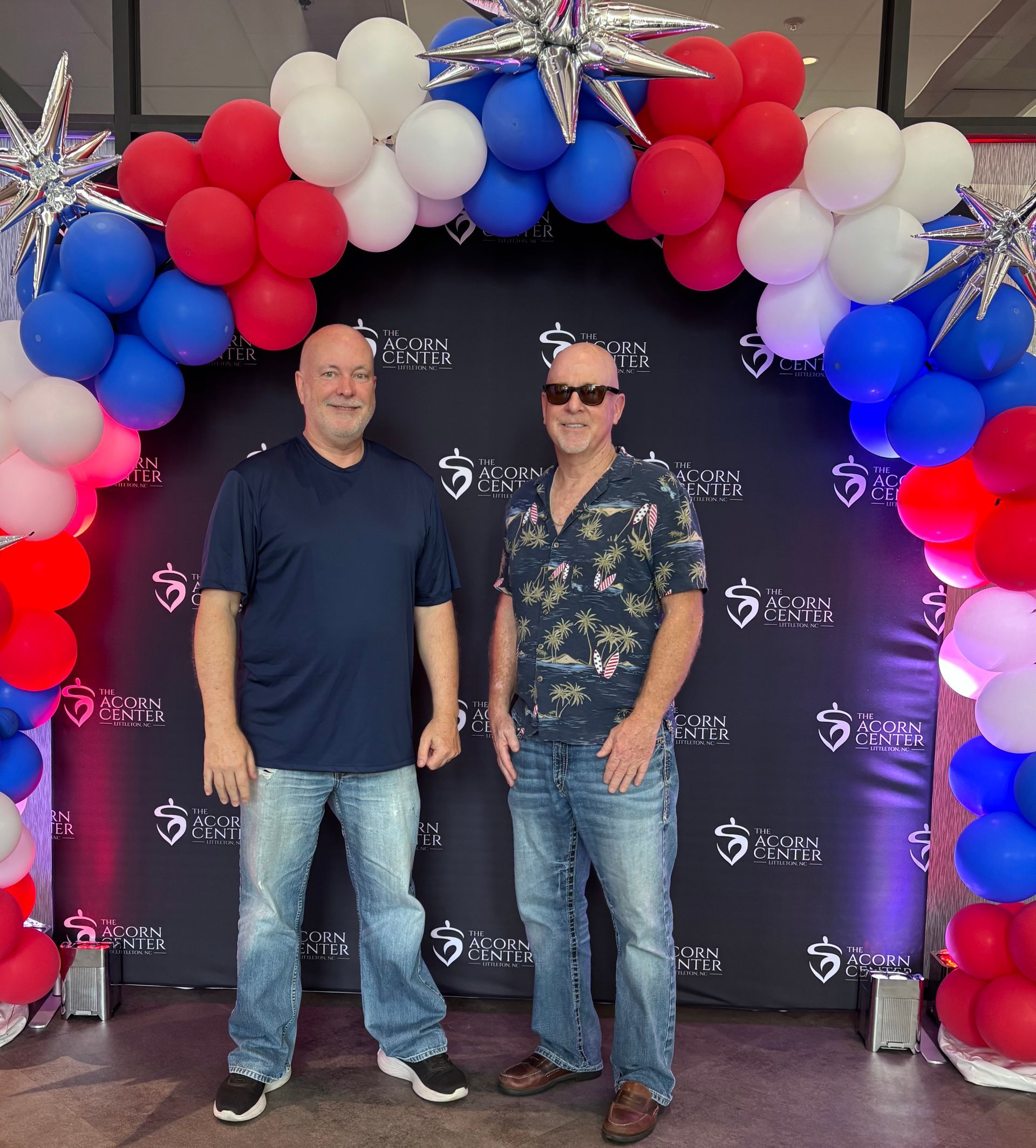 Tim and Phil in front of a patriotic backdrop