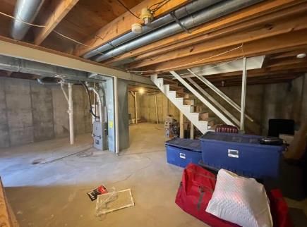 Contractor diligently assembling sleek kitchen cabinets in a new apartment.