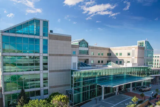Modern hospital or medical center with glass facades under a blue sky