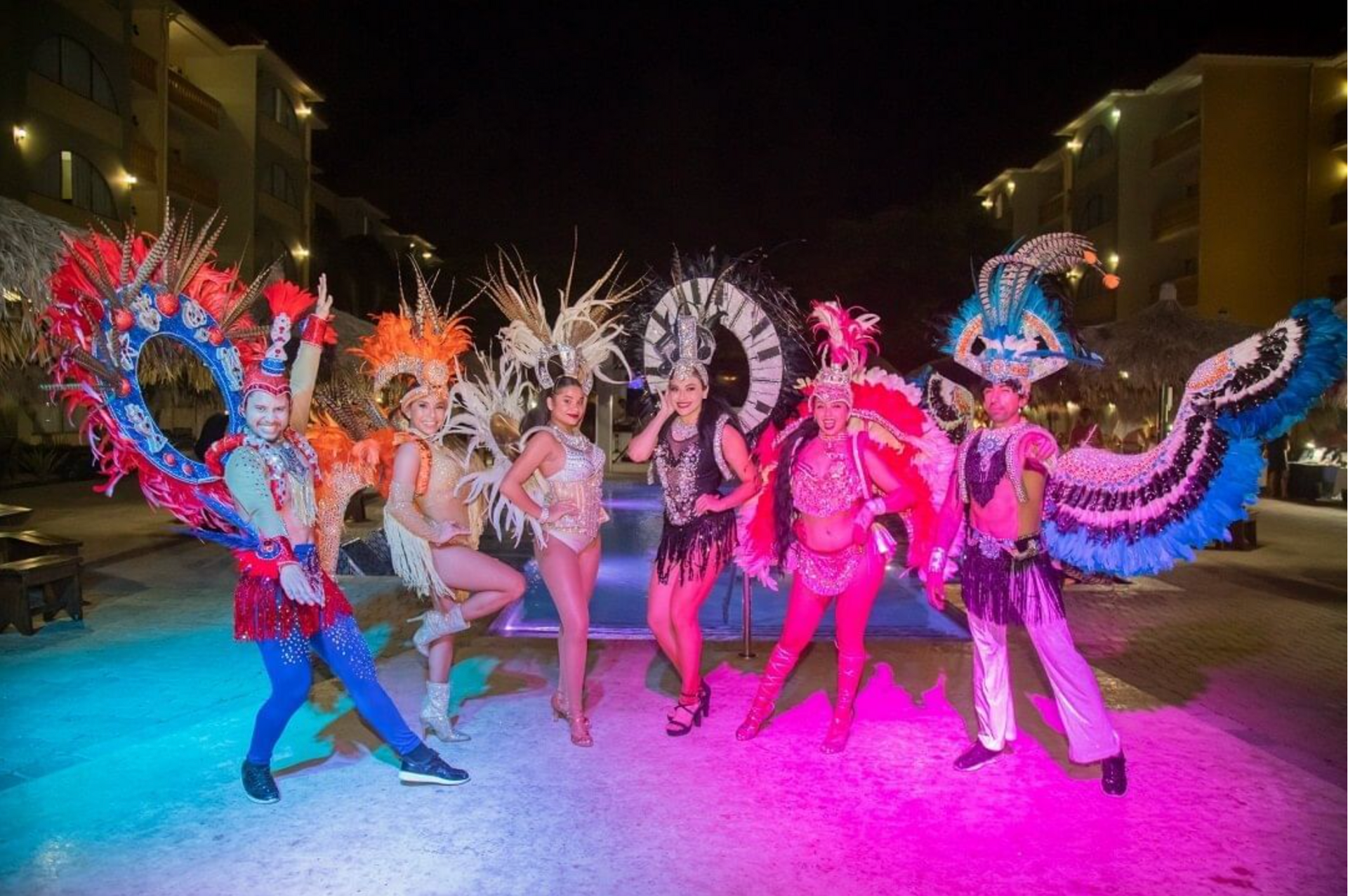 A group of people dressed in colorful costumes are standing next to each other.