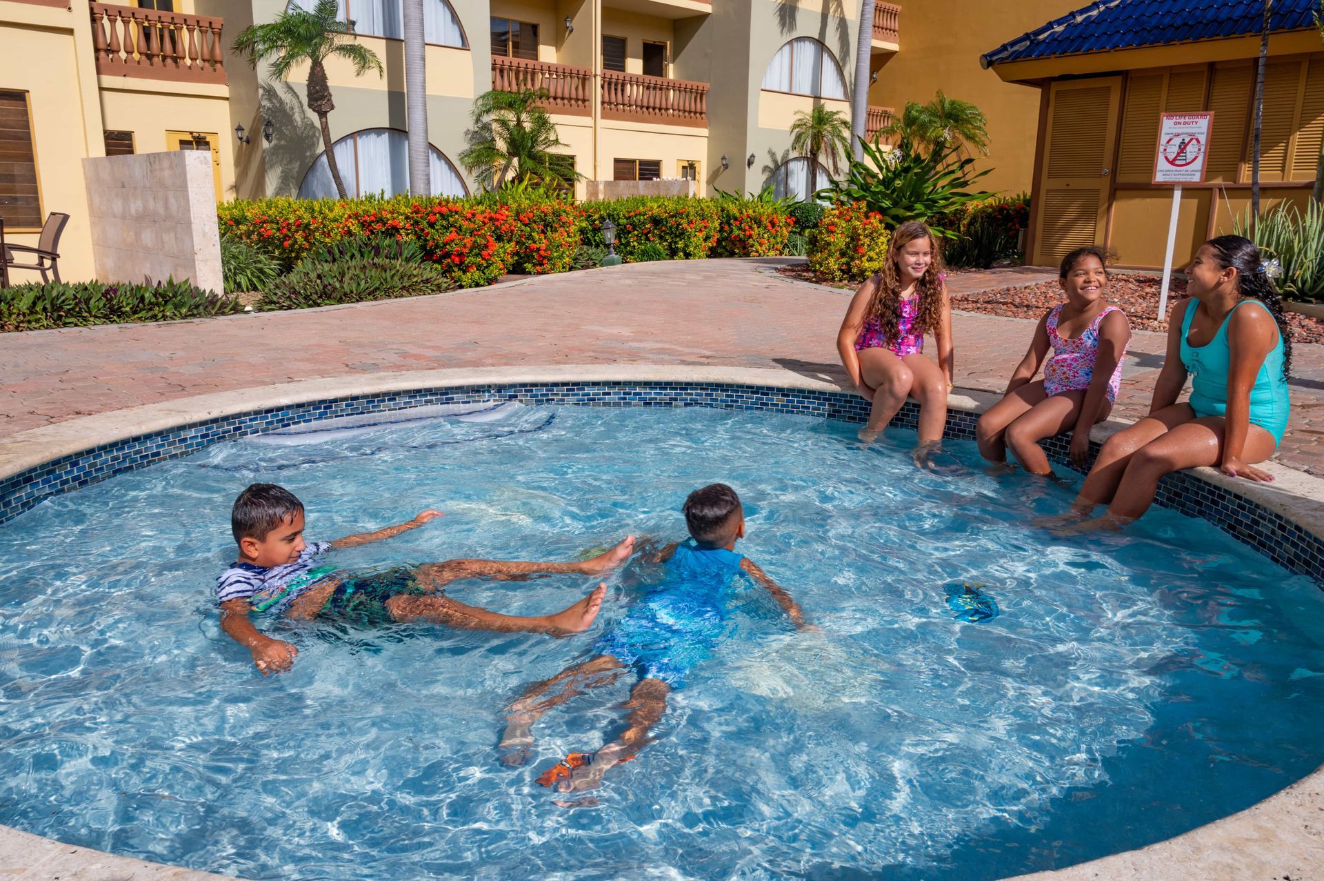 A group of children are playing in a swimming pool.