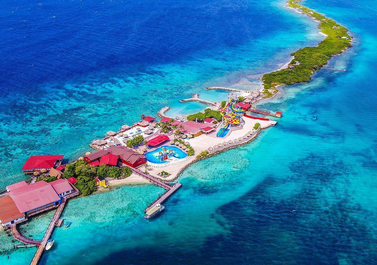 An aerial view of a beach with white sand and turquoise water.