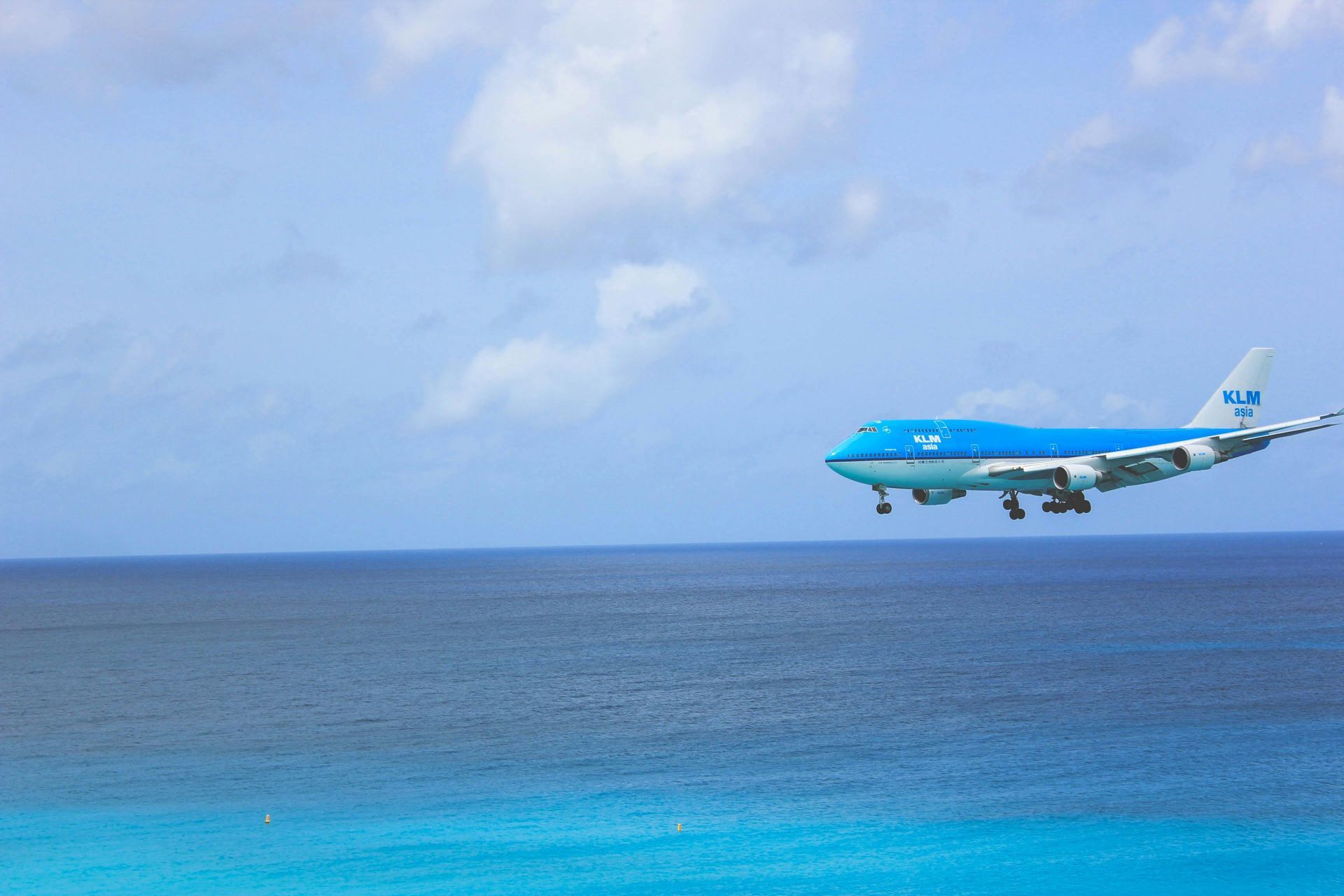 An aerial view of a beach with white sand and turquoise water.