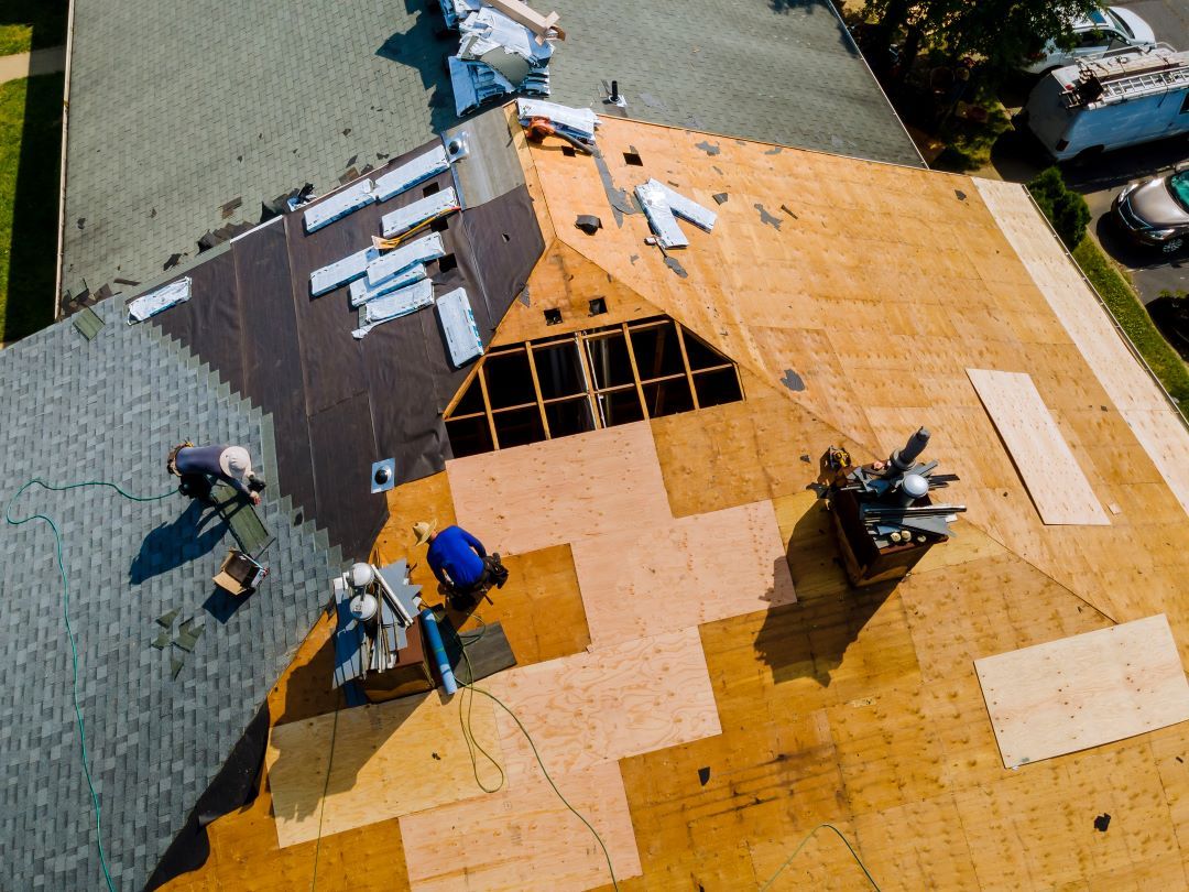 An aerial view of a roof being installed on a house.