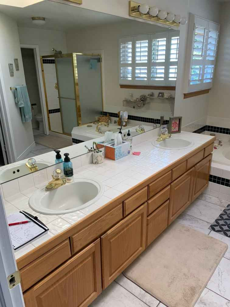 A bathroom with two sinks and a large mirror.