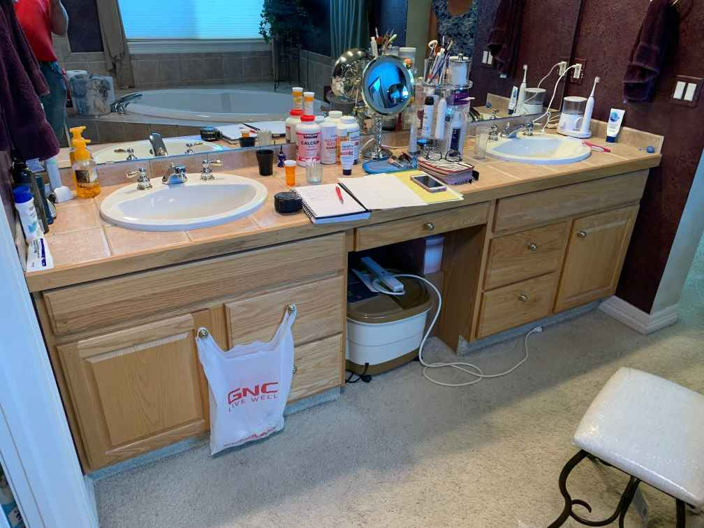 A bathroom with two sinks and a mirror.