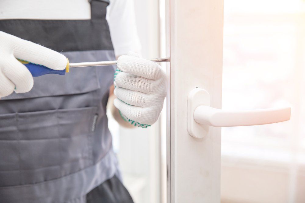 Worker Installing New Lock on Sliding Door — Contact Us in Launceston, TSA