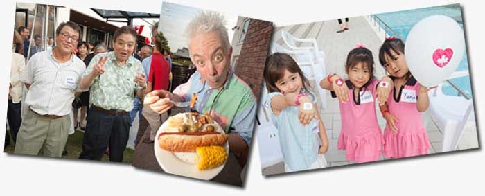 People enjoying food and festivities at an outdoor gathering. There are individuals holding balloons and plates of food.