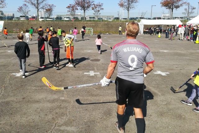 Adult in gray jersey with
