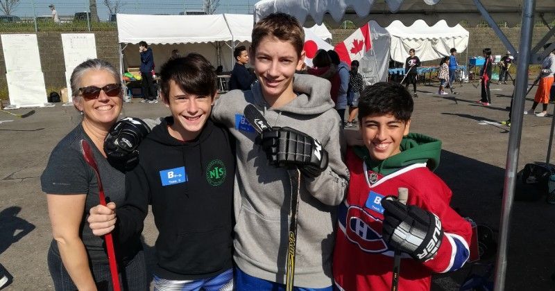 Kids (and a mom) enjoying a Canadian street hockey event in Mississauga Park in Kaiya City, Japan.