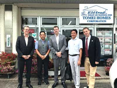 Five men standing in front of a building with the 