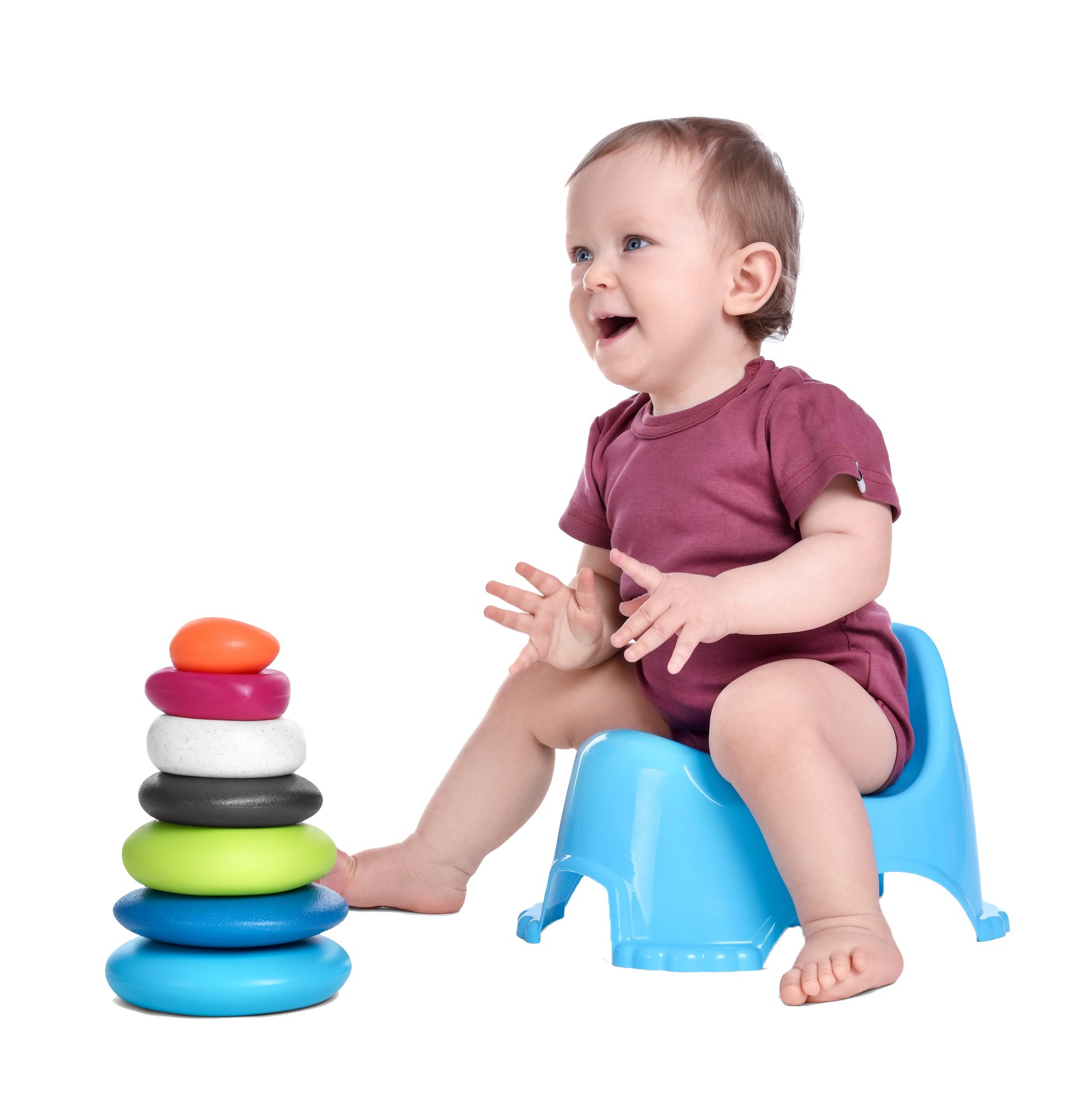Baby sitting on a blue potty, smiling at a colorful stacking toy.