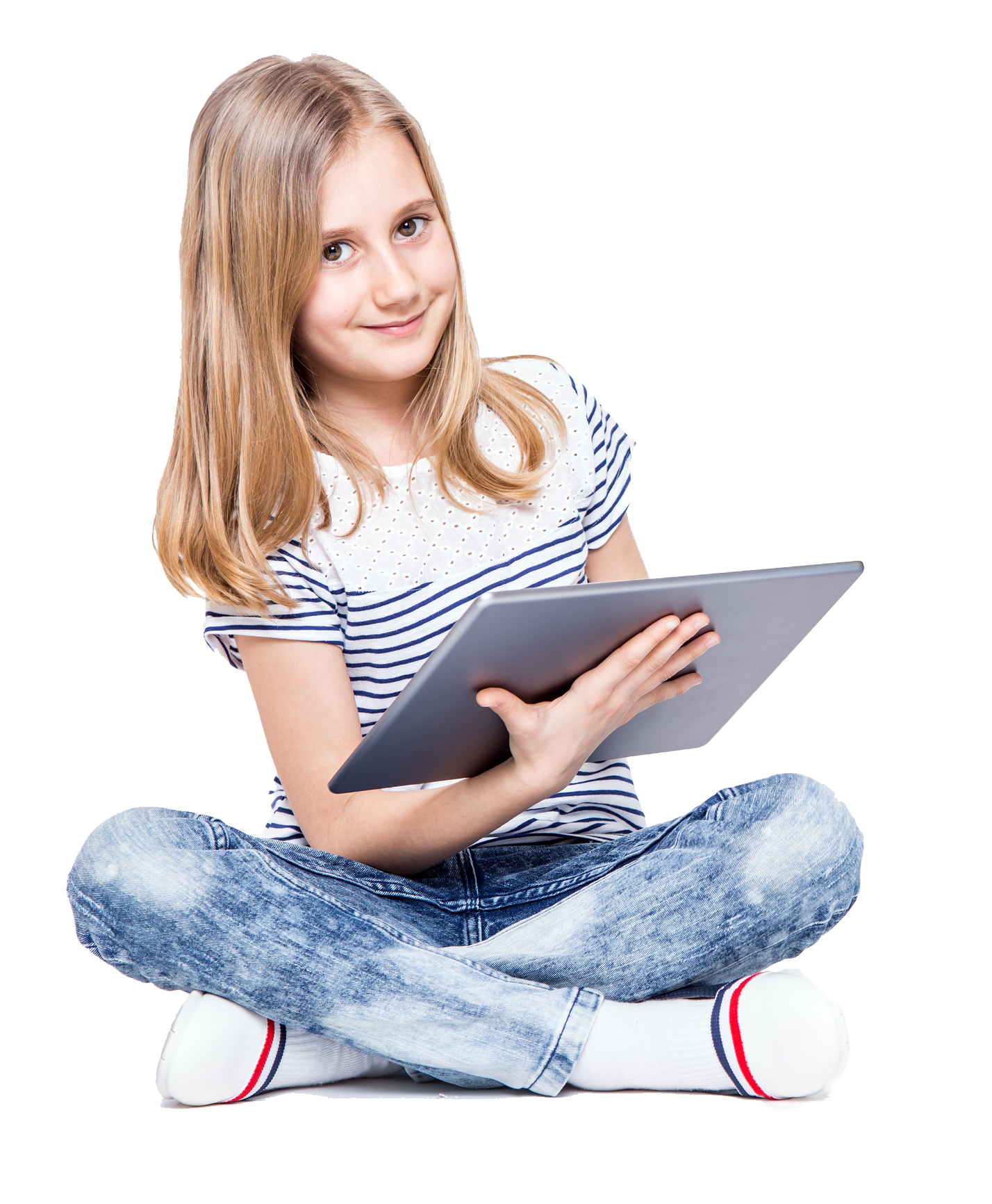 Girl sitting cross-legged, holding a tablet, smiling. She's wearing a striped shirt and jeans, on a white background.